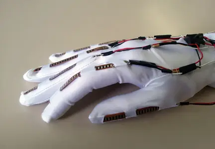 Photo of Specta Symbol Flex Sensors sewn into a glove for bio-feedback when hand moves